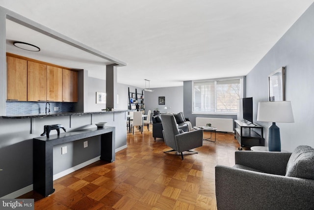 living room featuring light parquet floors and sink