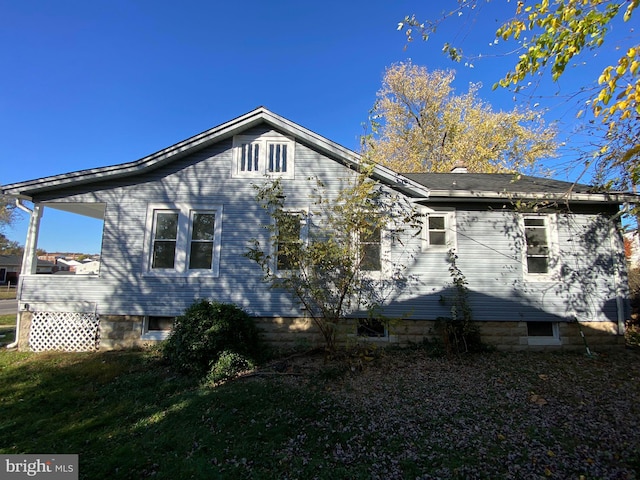 view of side of home with a lawn