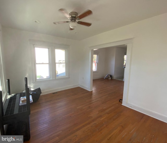 unfurnished living room with ceiling fan and dark hardwood / wood-style floors