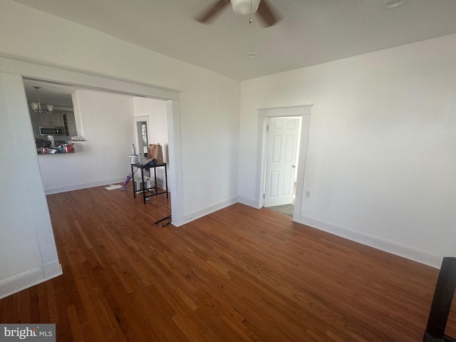 unfurnished room with ceiling fan and dark hardwood / wood-style flooring