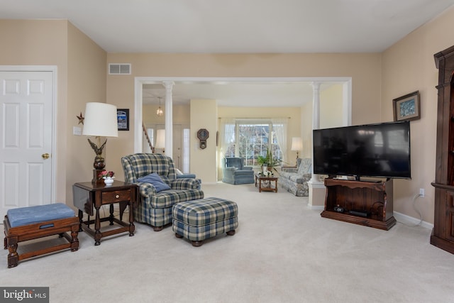 living room featuring carpet flooring and decorative columns