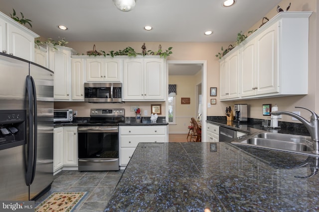 kitchen with sink, white cabinetry, and stainless steel appliances