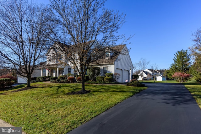 view of front facade with a front yard and a garage