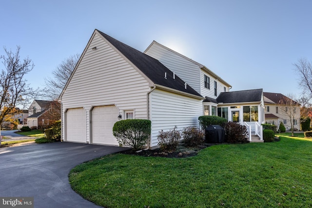 view of property exterior with a lawn and a garage