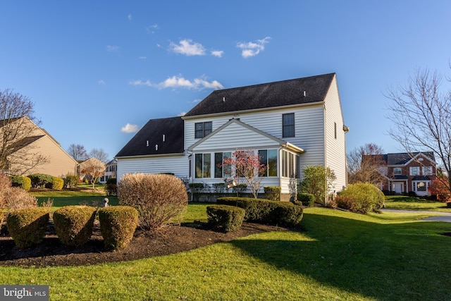 back of house with a lawn