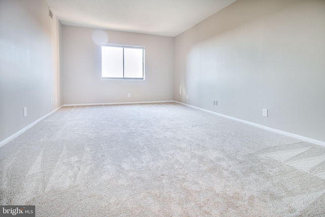 spare room with light colored carpet