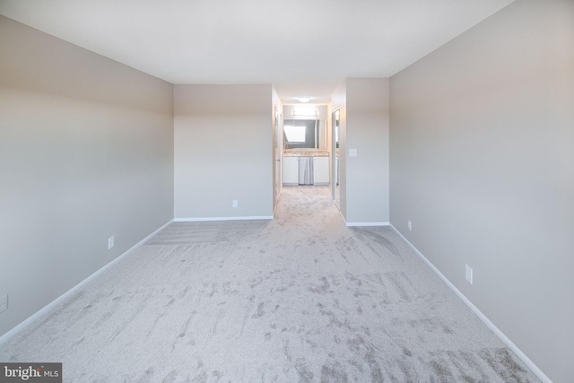 unfurnished room featuring light carpet