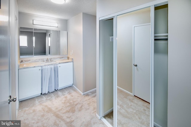 bathroom with vanity and a textured ceiling