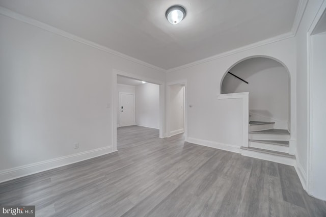 spare room featuring hardwood / wood-style flooring and ornamental molding