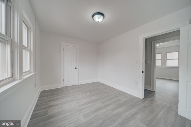 spare room with light hardwood / wood-style flooring