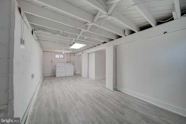 basement featuring hardwood / wood-style flooring and washer and dryer