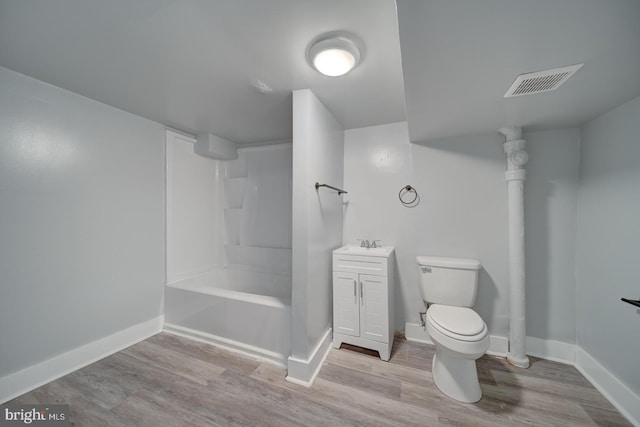 bathroom featuring vanity, hardwood / wood-style floors, and toilet