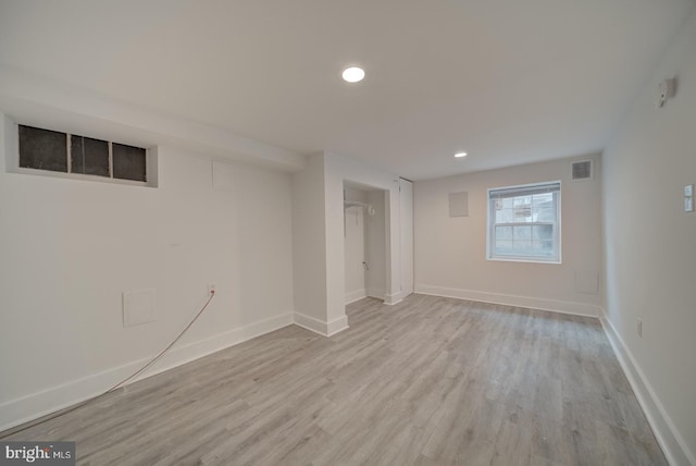 basement with light hardwood / wood-style floors