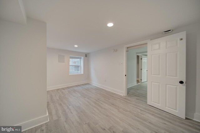 unfurnished room with light hardwood / wood-style flooring