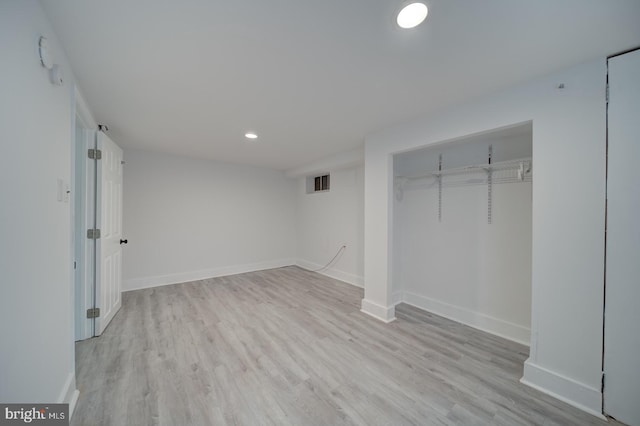 unfurnished bedroom featuring a closet and light hardwood / wood-style flooring