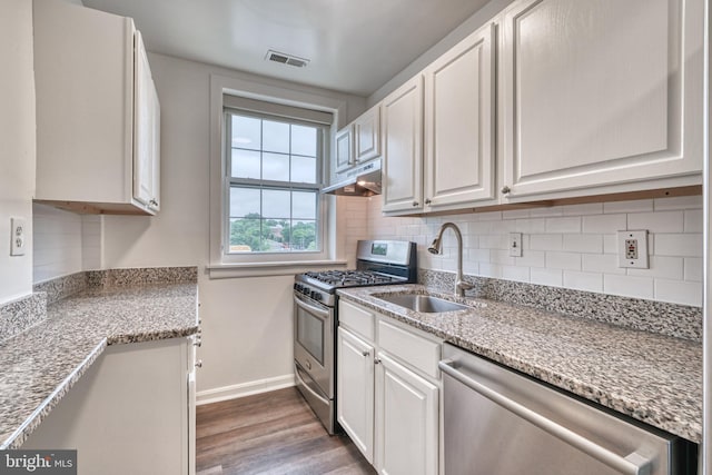 kitchen featuring dark hardwood / wood-style flooring, sink, white cabinetry, and stainless steel appliances