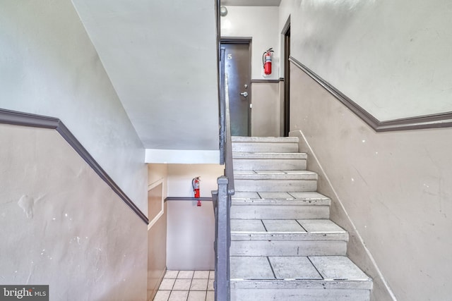 stairway with tile patterned floors