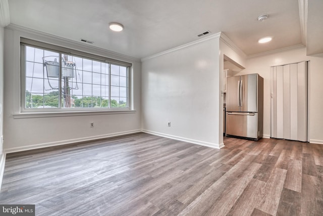 unfurnished dining area with light hardwood / wood-style flooring and crown molding