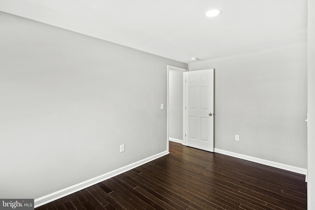 empty room with dark hardwood / wood-style floors