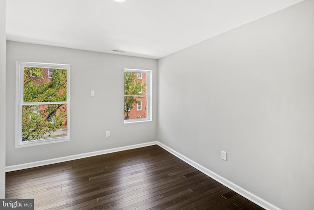 unfurnished room with dark hardwood / wood-style floors