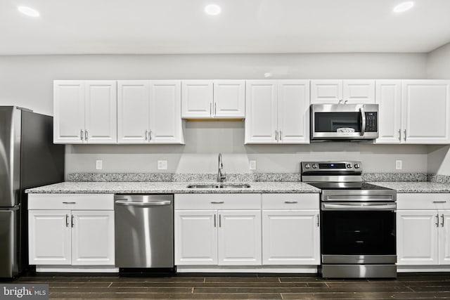 kitchen featuring white cabinetry, sink, and appliances with stainless steel finishes