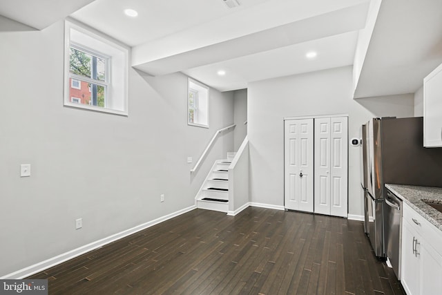 basement featuring dark hardwood / wood-style flooring and a wealth of natural light