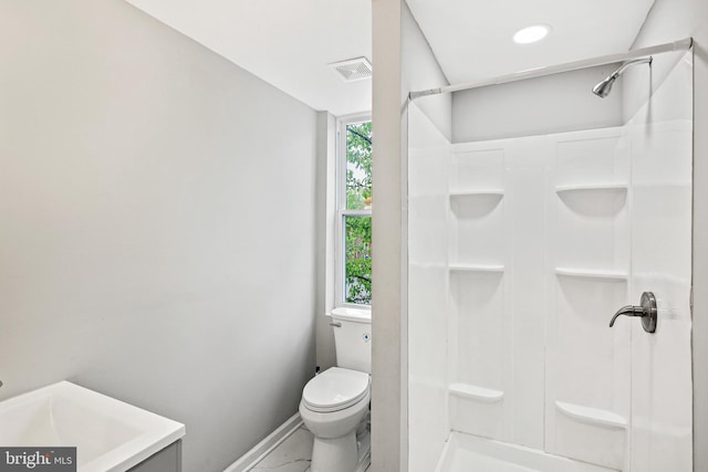 bathroom featuring walk in shower, vanity, and toilet