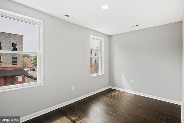 spare room with hardwood / wood-style flooring