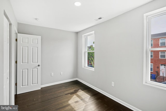 unfurnished bedroom with dark hardwood / wood-style floors