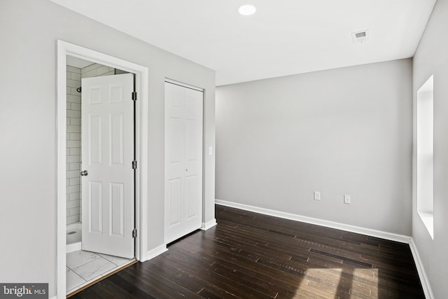 unfurnished bedroom with dark hardwood / wood-style flooring