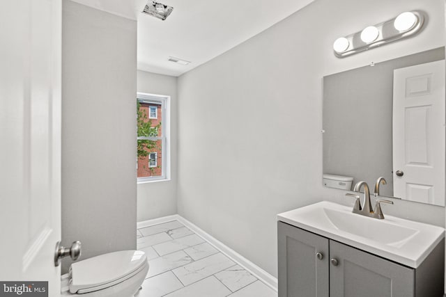 bathroom with vanity and toilet