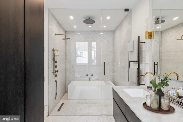 bathroom featuring vanity and a shower with door