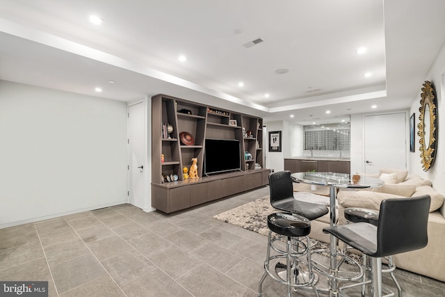 living room featuring a tray ceiling