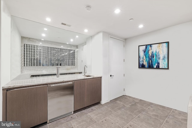 kitchen with white cabinets, stainless steel fridge, and sink