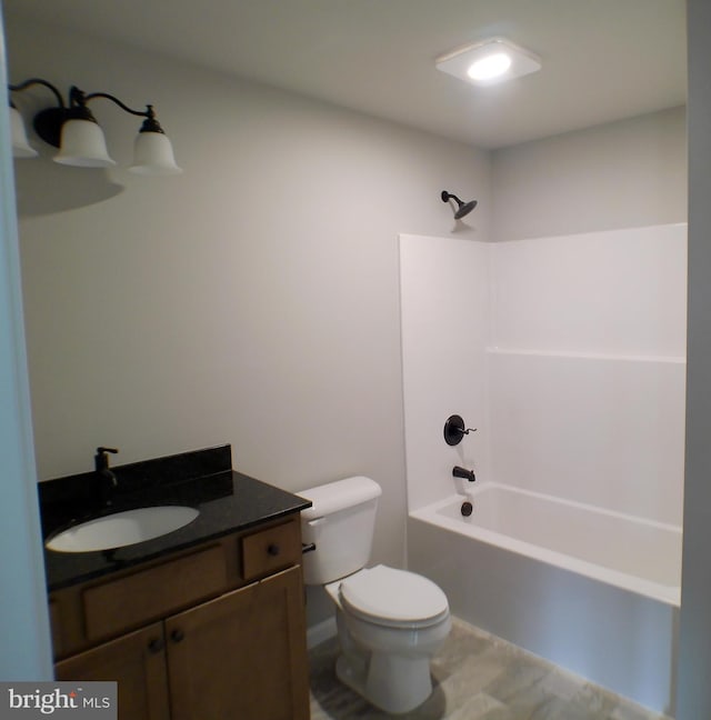 bathroom featuring tub / shower combination, vanity, and toilet