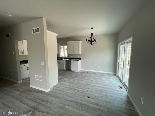 unfurnished dining area featuring a sink and visible vents