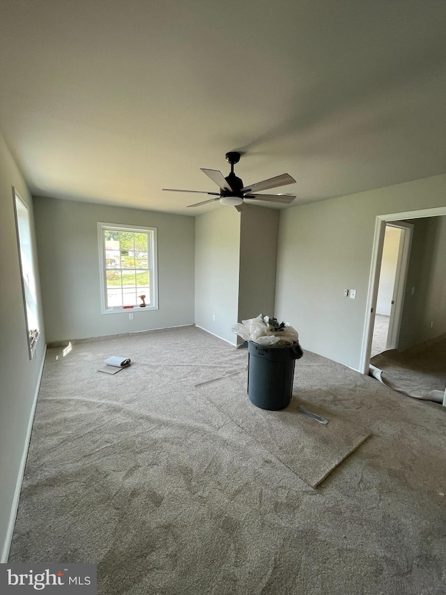 interior space with ceiling fan and carpet flooring