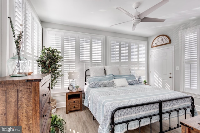 bedroom with light wood-type flooring and ceiling fan