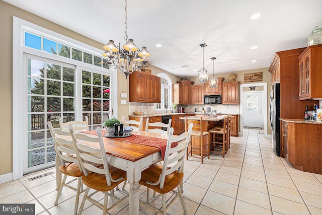 dining room featuring light tile patterned floors and a chandelier