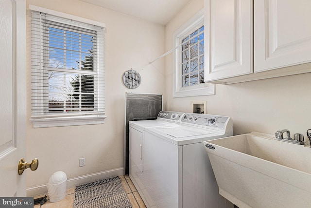 laundry room with cabinets, tile patterned flooring, separate washer and dryer, and sink