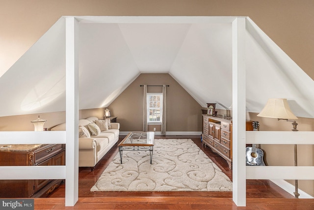 additional living space featuring hardwood / wood-style floors and vaulted ceiling