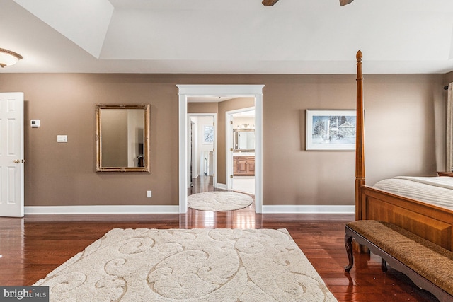 bedroom with dark hardwood / wood-style flooring, ensuite bathroom, and ceiling fan