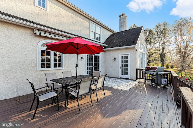 wooden deck with a grill