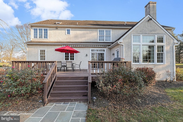 rear view of property with a wooden deck