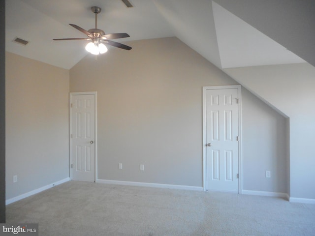 additional living space featuring lofted ceiling, light carpet, and ceiling fan