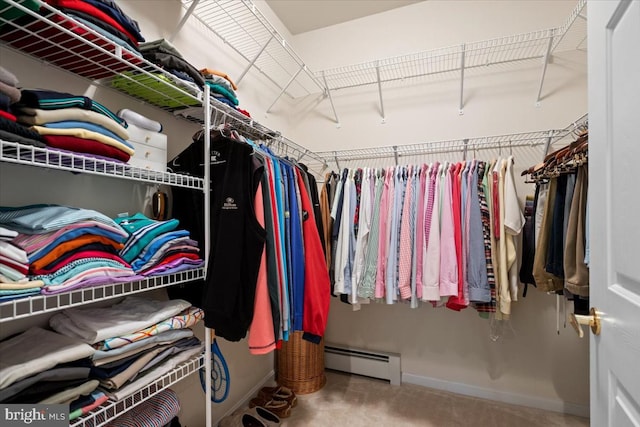 spacious closet with carpet floors and a baseboard heating unit