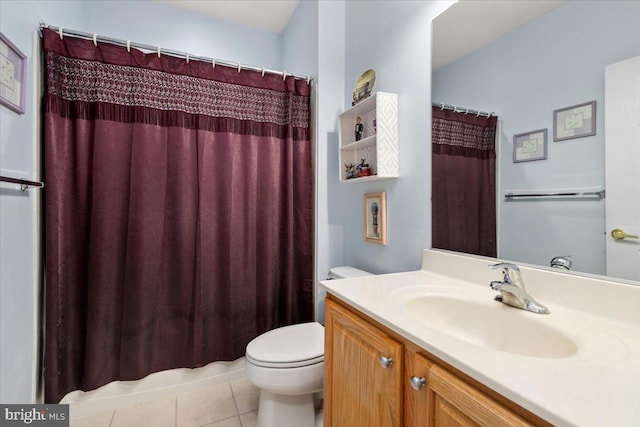 bathroom featuring tile patterned floors, vanity, curtained shower, and toilet