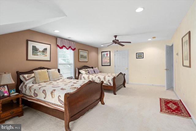 carpeted bedroom with ceiling fan and vaulted ceiling