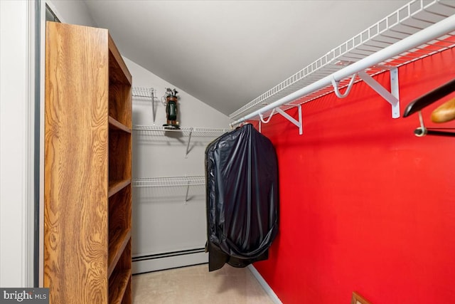 spacious closet with carpet and baseboard heating