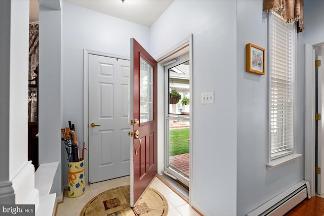 foyer featuring light tile patterned floors and baseboard heating